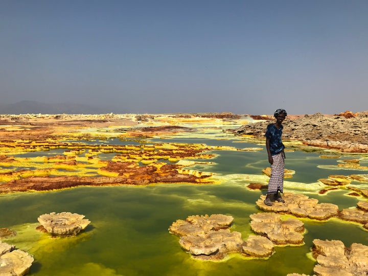 <p>Arata, our Afar guide, leading us across the Dallol pools</p>