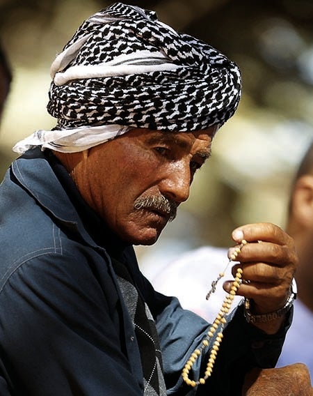 <p><em>A Maronite participates in a mass in the cedars forest in the northern Lebanese village of Bsharreh (courtesy Patrick Baz)</em></p>