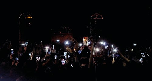 <p><em>Greek Orthodox believers take pictures of the Holy Fire as it arrives from Jerusalem through Jordan to the St. George Cathedral in downtown Beirut (courtesy AFP)</em></p>