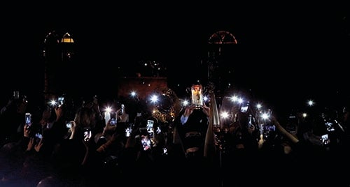 Greek Orthodox believers take pictures of the Holy Fire as it arrives from Jerusalem through Jordan to the St. George Cathedral in downtown Beirut (courtesy AFP)