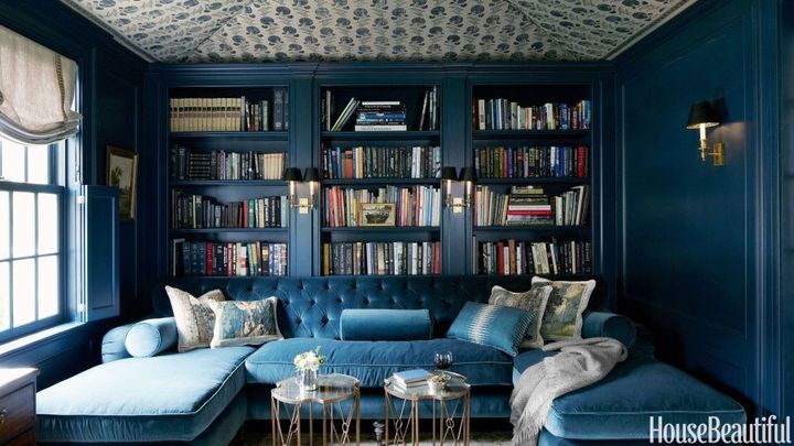 Above, dark blue hues create a jewel box feel in the home library of designer Jeannette Whitson, as featured in House Beautiful.