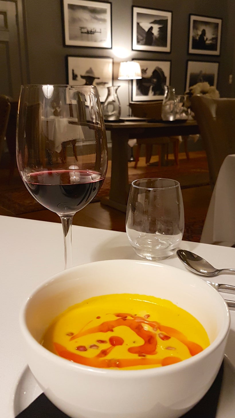 A glass of malbec and wintery bowl of butternut squash velouté, served by Kendal Heraty—one of the wonderful staff who call G