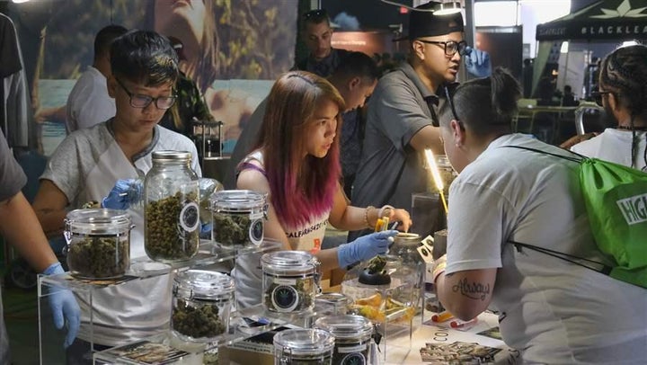 A medical marijuana provider helps attendees at the High Times Cannabis Cup in San Bernardino, California. Last month Califor