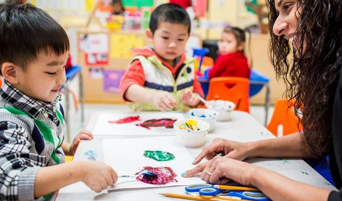 Children in the City’s free Pre-K classes learn about colors while painting.