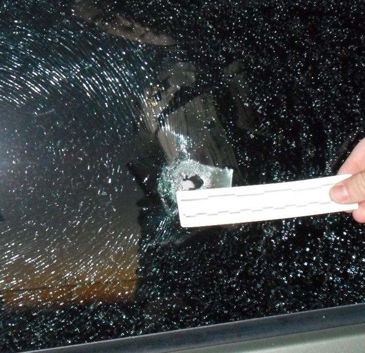 A bullet hole from one victim's vehicle window, in an image provided by the Fresno County Sheriff's Department.