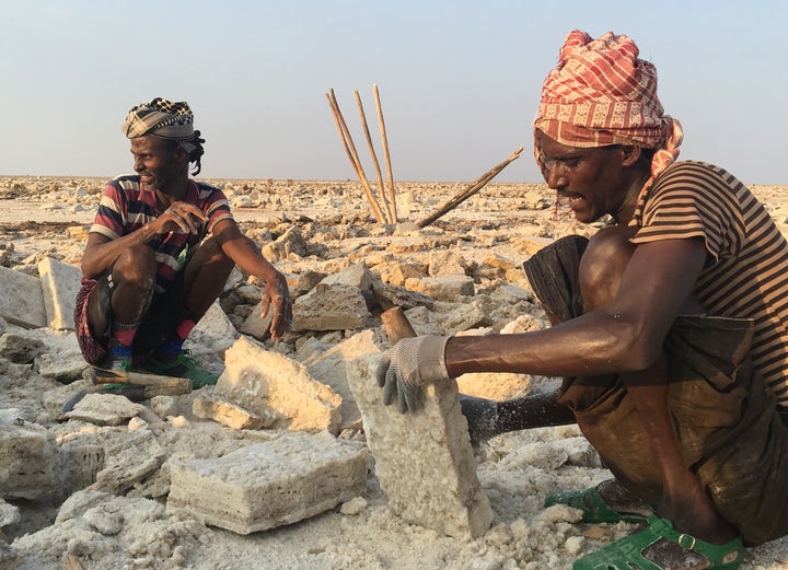 <p>Miners carving-out salt slabs at the salt lake near Hamed Ela</p>