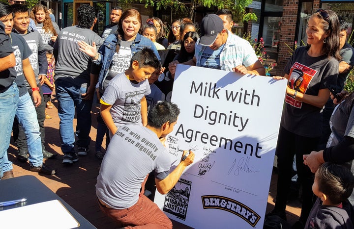 Members of Migrant Justice's farmworker coordinating committee sign the Milk with Dignity agreement.