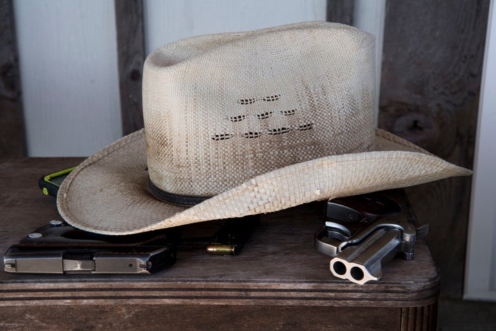 Guns lie underneath a hat in a home in Sutherland Springs, Texas, Nov. 6, 2017.