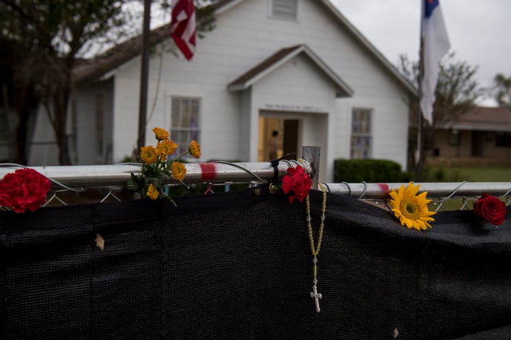 A rosary hangs on the fence surrounding First Baptist Church one week after 26 people were killed in Sutherland Springs, Texas.