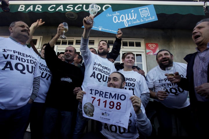 People who bought winning tickets in Spain's Christmas Lottery celebrate in Vilalba on Friday. 