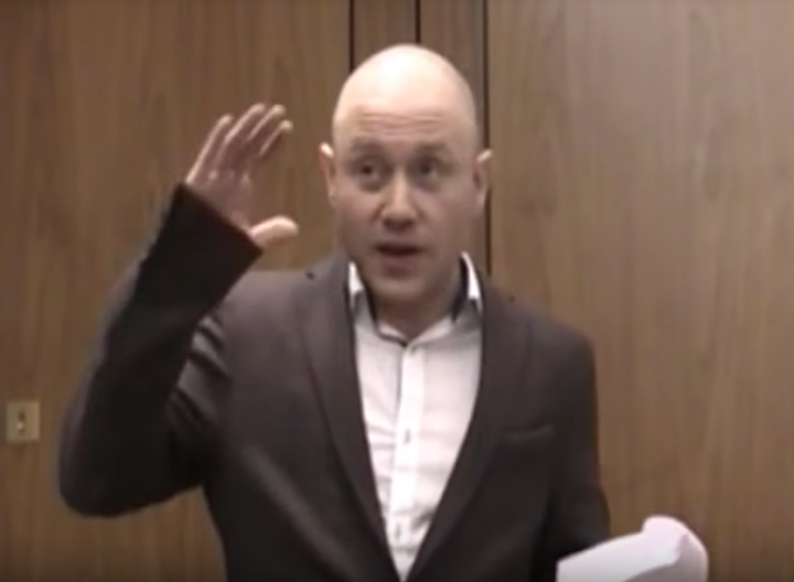 Andrew Anglin, wearing an oversized sport coat, delivers a racist, anti-Semitic speech in London in April 2014.