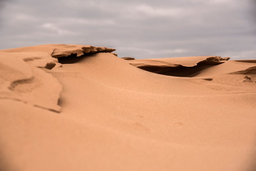 Sand looking a lot like frozen waves on the dunes.