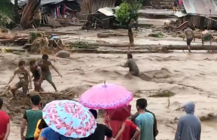 People help to rescue flood victims in Lanao del Norte, Philippines 