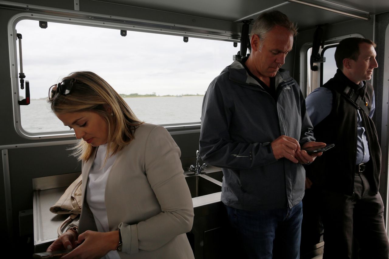 Downey Magallanes, left, and then-Interior Secretary Ryan Zinke, center, after a visit to Georges Island in Boston Harbor, Massachusetts, in June 2017. Magallanes now has a senior government affairs job at oil giant BP.