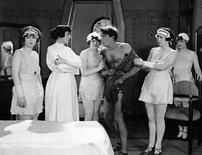 Elmer Smith (Earle Foxe) gets a medical checkup from Dr. Prodwell (Clarissa Selwynne) in a scene from 1924's The Last Man on Earth