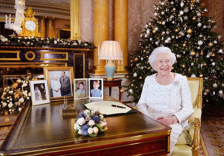 Queen Elizabeth II at a desk in the 1844 Room at Buckingham Palace, London, after recording her Christmas Day broadcast to the Commonwealth 