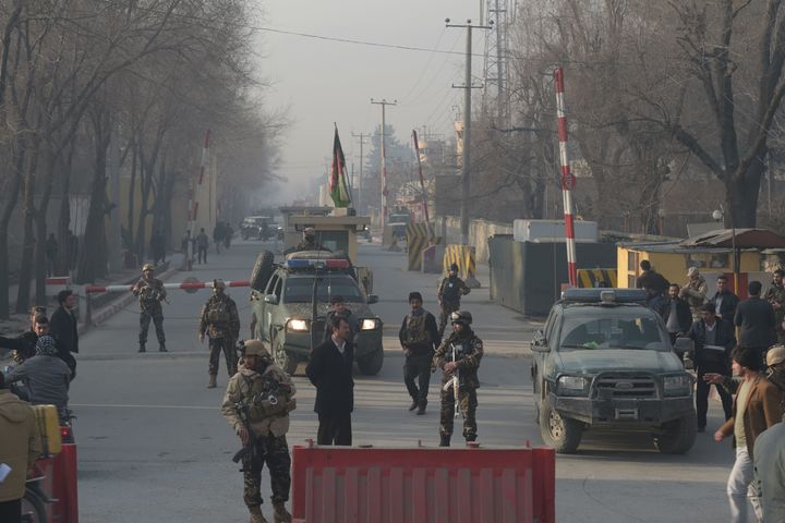 Afghan security personnel block a road near the site of a suicide attack in Kabul on Dec. 25, 2017.