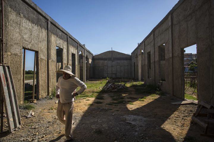 <p>A man walks through the framing of what will soon be the first new Catholic church in Cuba since Fidel Castro came to power in 1959.</p>
