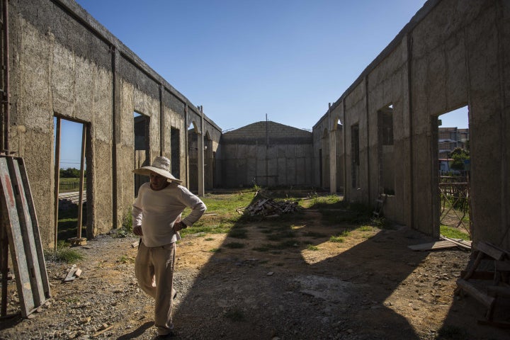 <p>A man walks through the framing of what will soon be the first new Catholic church in Cuba since Fidel Castro came to power in 1959.</p>