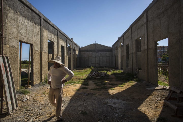 A man walks through the framing of what will soon be the first new Catholic church in Cuba since Fidel Castro came to power in 1959.