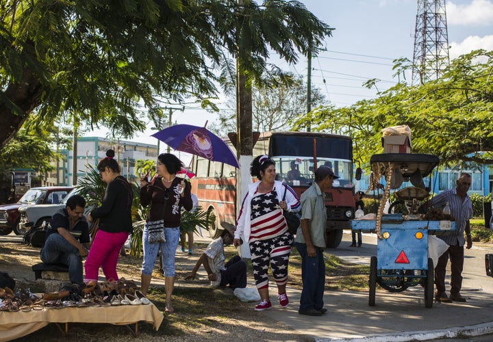 A woman walks around Sandino wearing American flag-patterned clothing.