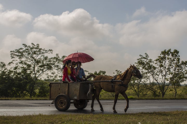 A horse and buggy drive on a road in Sandino, Cuba. 