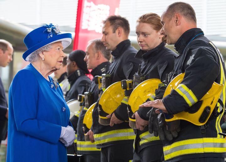 The Queen meets firefighters during a visit to the Westway Sports Centre after fire engulfed the Grenfell Tower in west London 