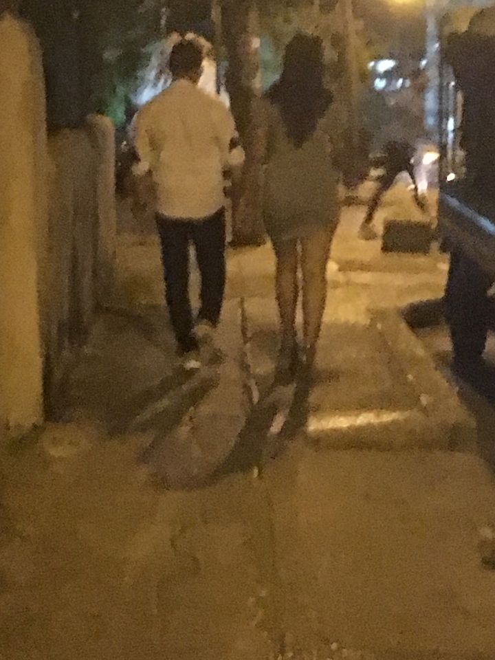 A prostitute escorts an American tourist to a casa particular in Havana.