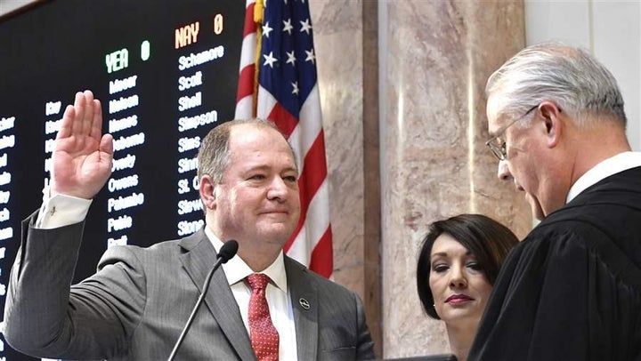 Republican Kentucky state Rep. Jeff Hoover, left, is sworn in as House speaker. Hoover resigned his post as speaker this month after he was accused of sexual harassment.