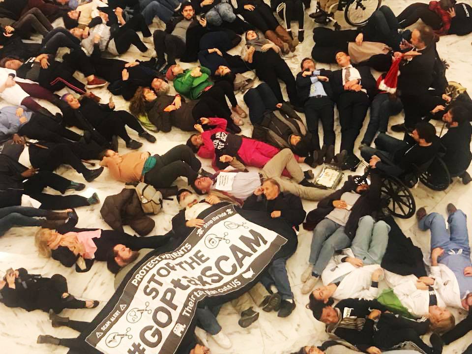 Ady Barkan and dozens of other protesters participate in a die-in against the GOP tax bill in the Russell Senate Office Building on Dec. 18, 2017.