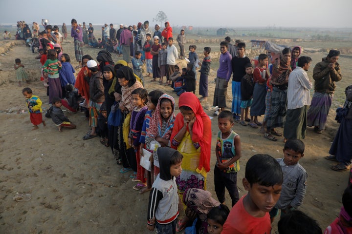 Rohingya refugees wait for a rice delivery at a Bangladesh camp in December. 