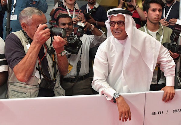 DIFF Chairman Abdulhamid Juma poses in the photographer’s pit during the closing night’s red carpet for the 14th edition of t