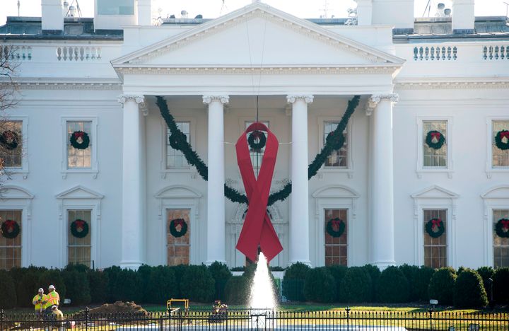 A red ribbon in recognition of World AIDS Day hangs from the North Portico of the White House in Washington, D.C.