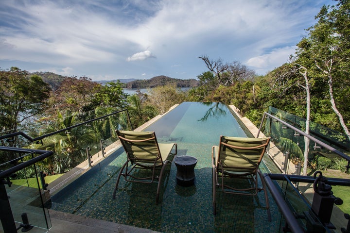 <p>Coves and distant peaks seen from Villa Manzu’s infinity pool (one of two), stretch away to the sky, Villa Manzu, Costa Rica. </p>