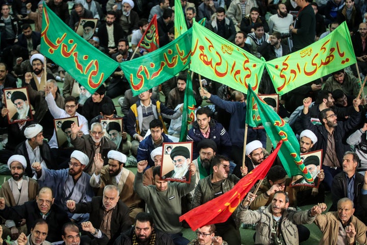 Iranians chant slogans as they march in support of the government near the Imam Khomeini grand mosque in the capital Tehran on December 30, 2017.