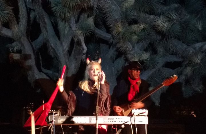 Jesika Von Rabbit performs on the Quema Stage in front of a staturesque joshua tree.