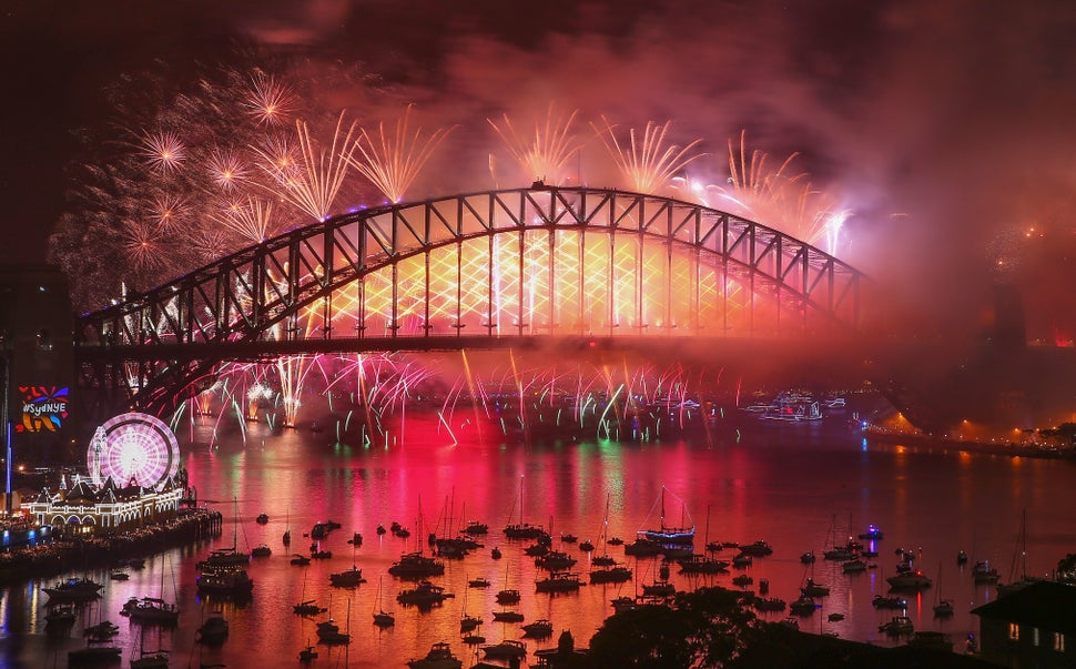 Fireworks explode from the Sydney Harbour Bridge and the Sydney Opera House during the midnight fireworks display on New Year's Eve on January 1, 2018 in Sydney, Australia.