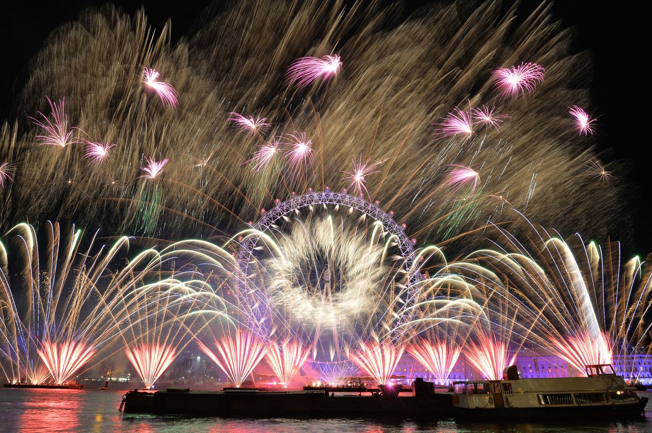 Fireworks light up the sky over the London Eye in central London during New Year's celebrations.