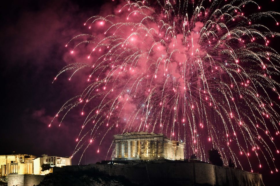 Fireworks explode over the Acropolis in Athens during New Year's celebrations on December 31, 2017.
