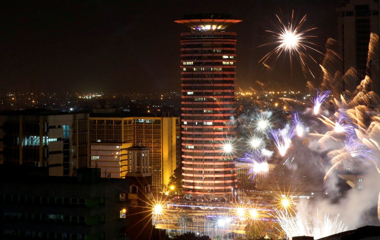 Fireworks explode over the Kenyatta International Convention Center square during New Year's celebrations in Nairobi, Kenya on January 1, 2018.