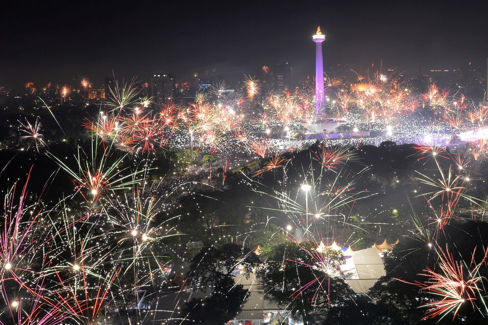 Fireworks explode around the National Monument during New Year's celebrations in Jakarta, Indonesia on January 1, 2018.