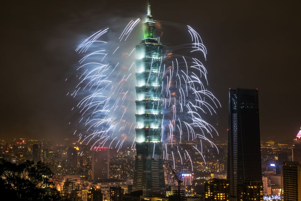Fireworks light up the skyline in Taipei just after midnight on January 1, 2018.