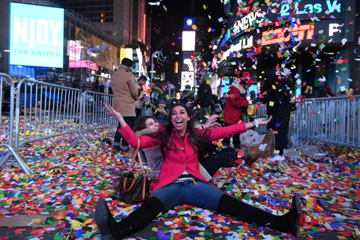 Revelers play in confetti in Times Square during the New Year's Eve celebration.