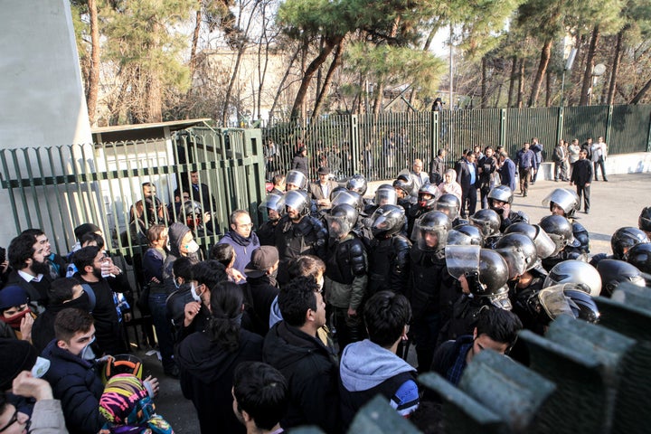 Iranian students scuffle with police at the University of Tehran during a demonstration driven by anger over economic problem