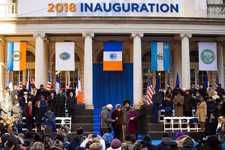 Sen. Bernie Sanders (I-Vt.) swears in New York City Mayor Bill de Blasio for a second term after a speech on Monday afternoon. First lady Chirlane McCray and the couple's two children, Dante and Chiara, stand between the two men.