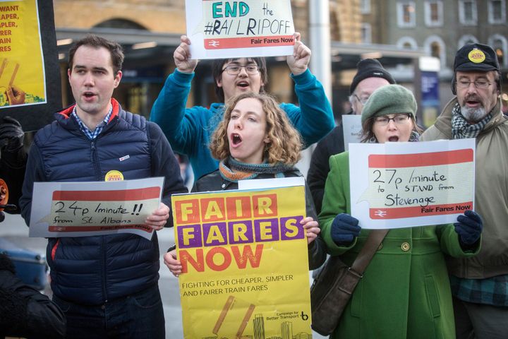 Protesters for 'Campaign for Better Transport' sing as part of a flash mob demonstration against rail fare rises outside Kings Cross in London