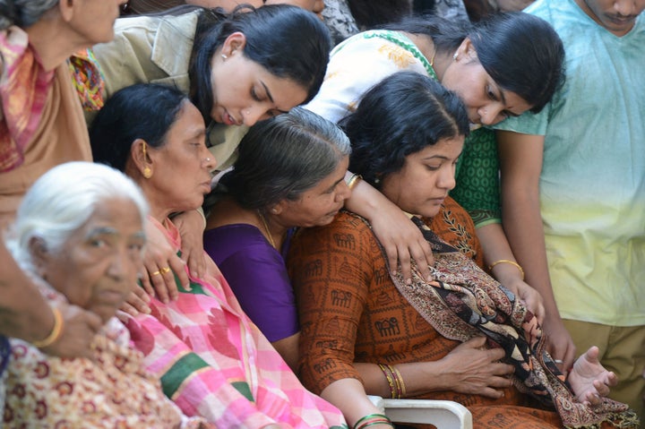 Sunayana Dumala (R), wife of the slain Indian engineer Srinivas Kuchibhotla is consoled by family members prior to performing the last rites at his funeral in Hyderabad on February 28, 2017. 