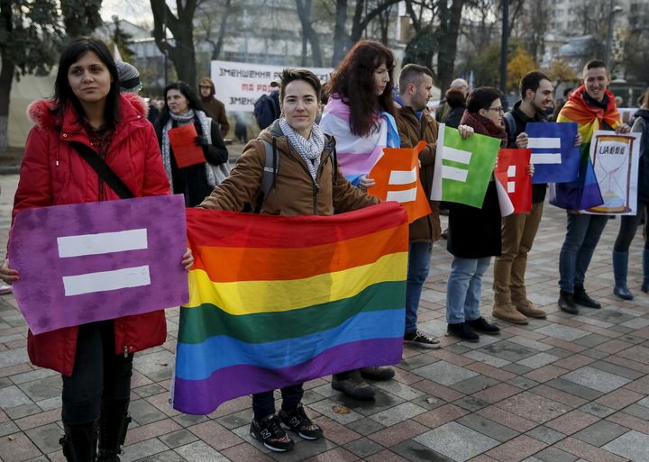 LGBTQ activists attend a rally outside the parliament building in Kiev, Ukraine. 