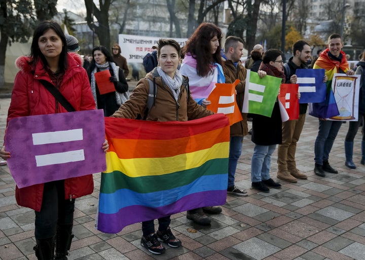 LGBTQ activists attend a rally outside the parliament building in Kiev, Ukraine. 