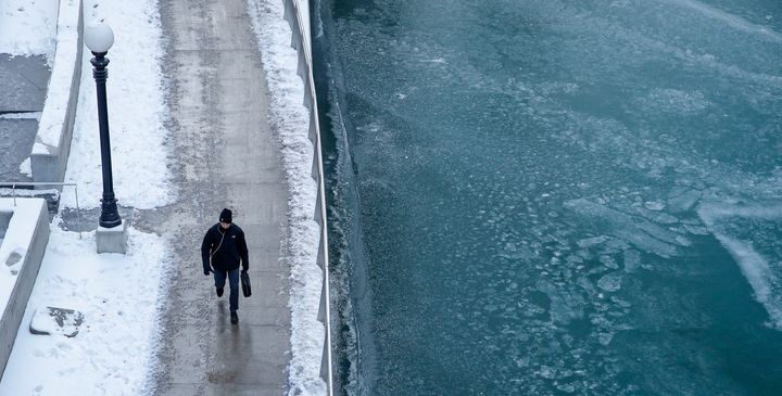 A pedestrian walks along the Chicago River on December 27, 2017 in Chicago, Illinois.